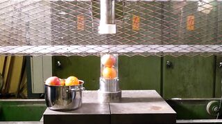 Crushing fruits through a small hole with hydraulic press
