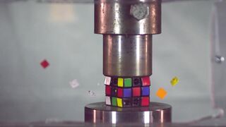 SUPER SLOW MOTION: rubik's cube and hockey puck with hydraulic press