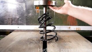 Crushing car spring with hydraulic press