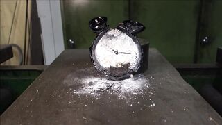 Crushing alarm clock with hydraulic press