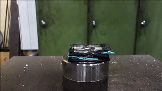 Crushing mobile phone with hydraulic press